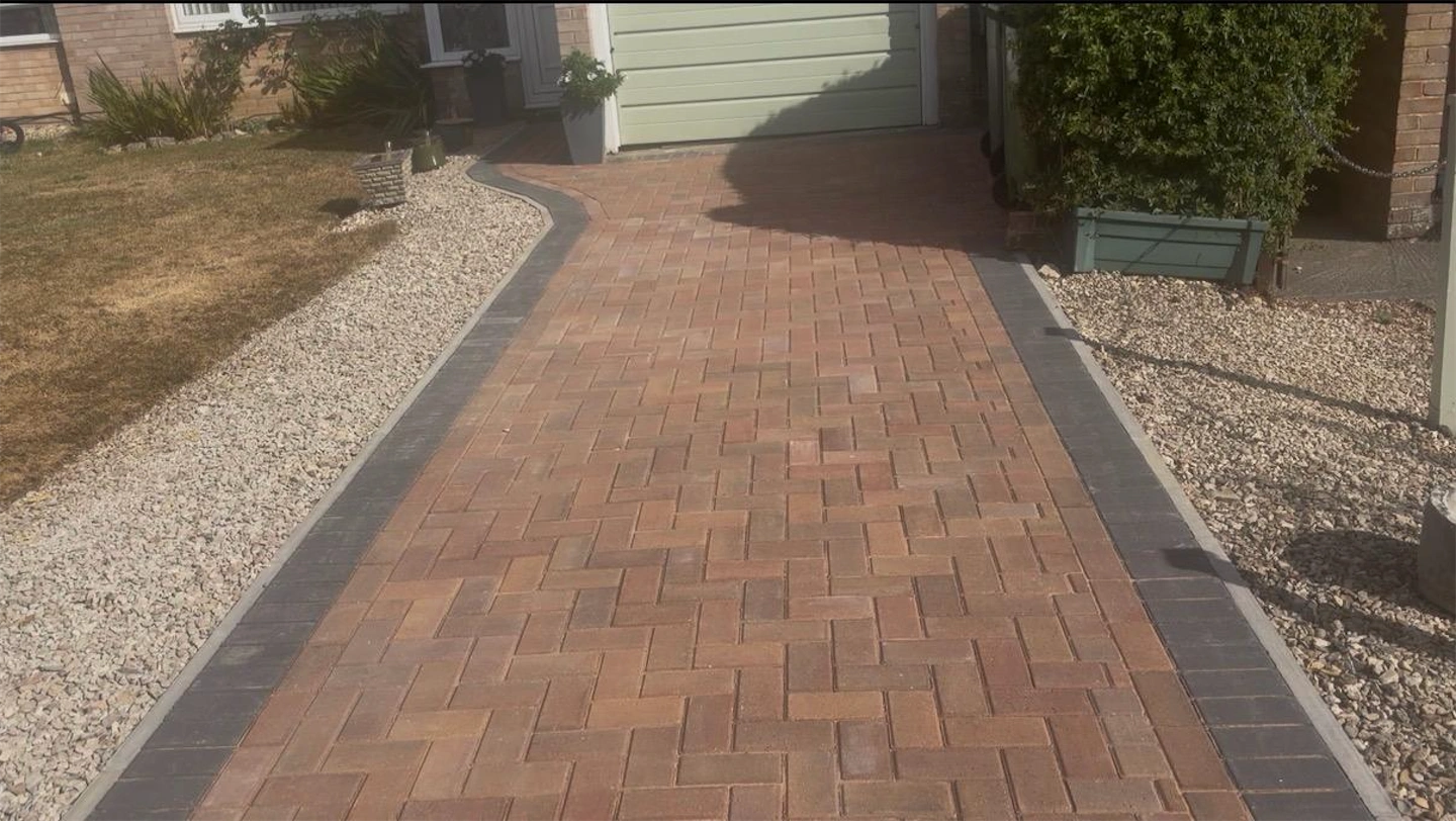 Newly installed herringbone block paving driveway with charcoal border edging, Trowbridge, Wiltshire