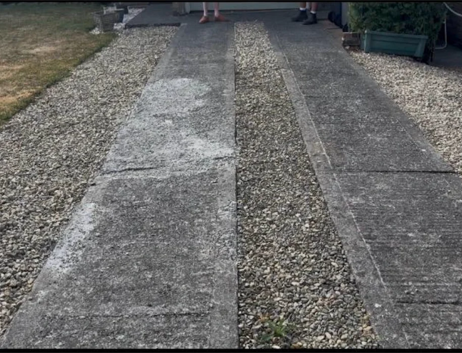 Damaged and cracked concrete slab driveway before replacement with block paving