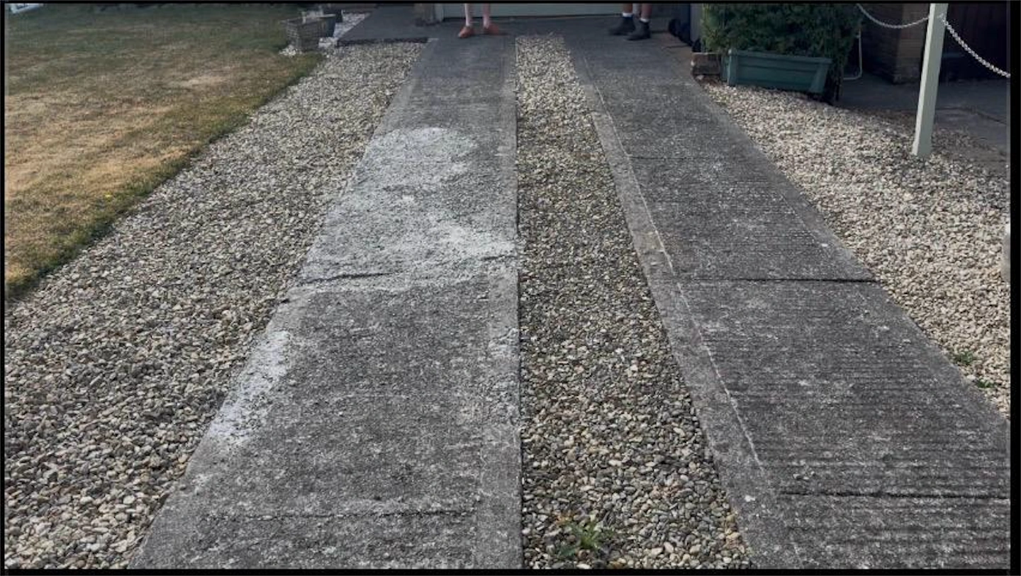 Damaged and cracked concrete slab driveway before replacement with block paving